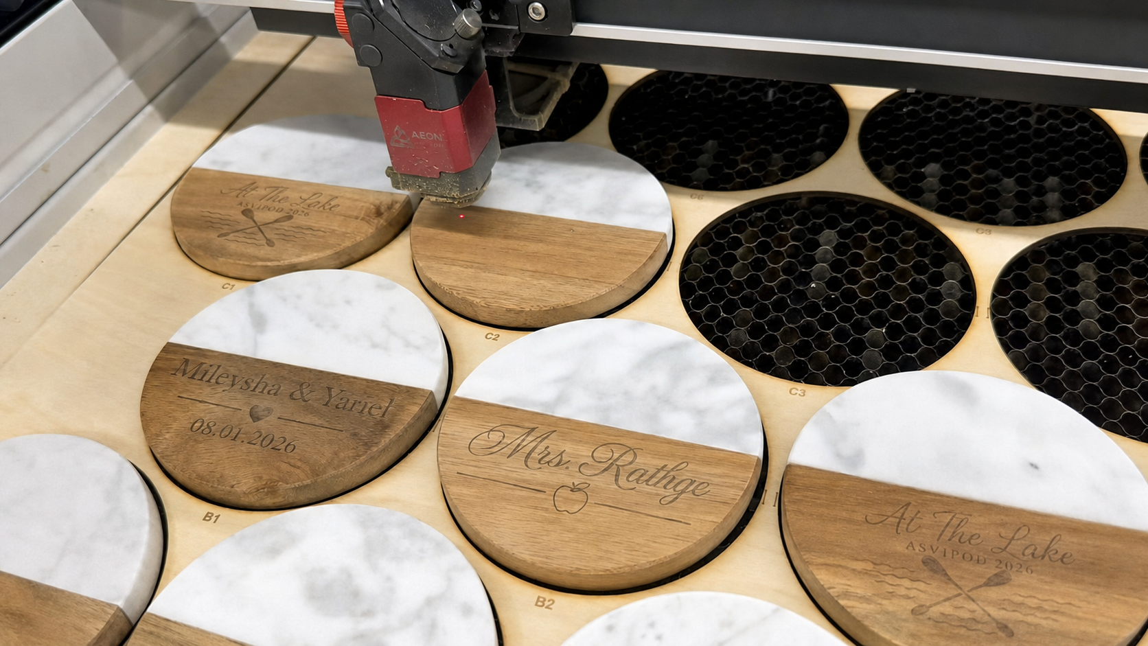 Laser engraving personalized wood-and-marble coasters in the MyMaravia workshop