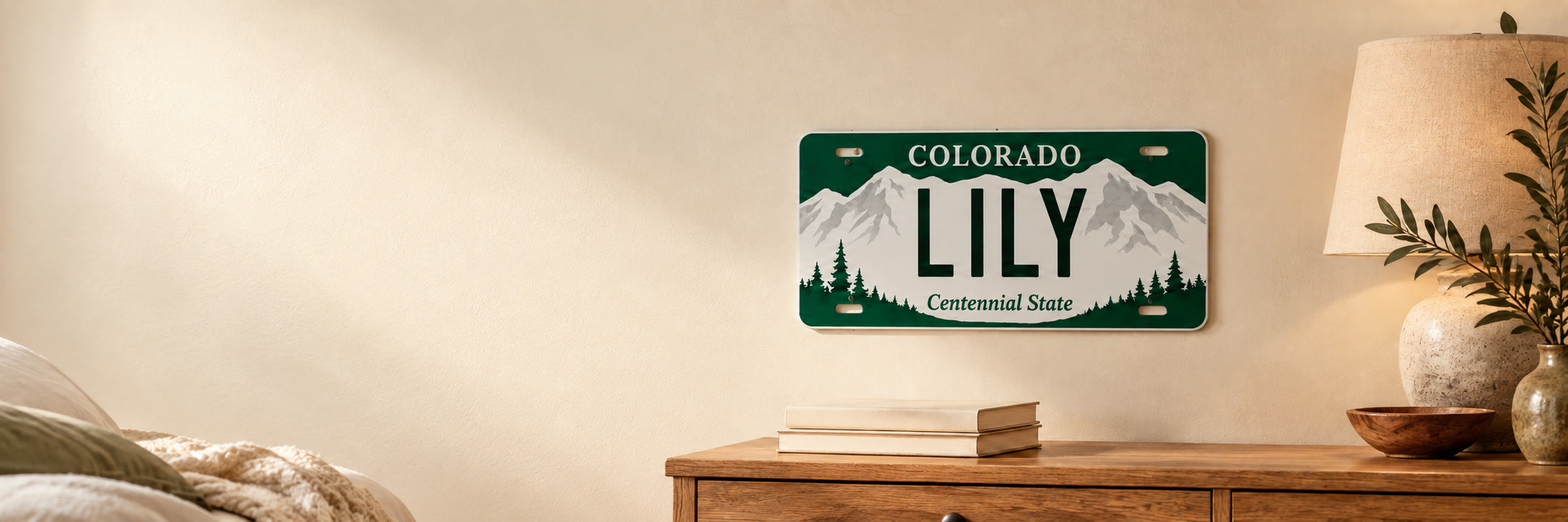 Colorado-style personalized Lily license plate displayed above an oak dresser in a warm bedroom