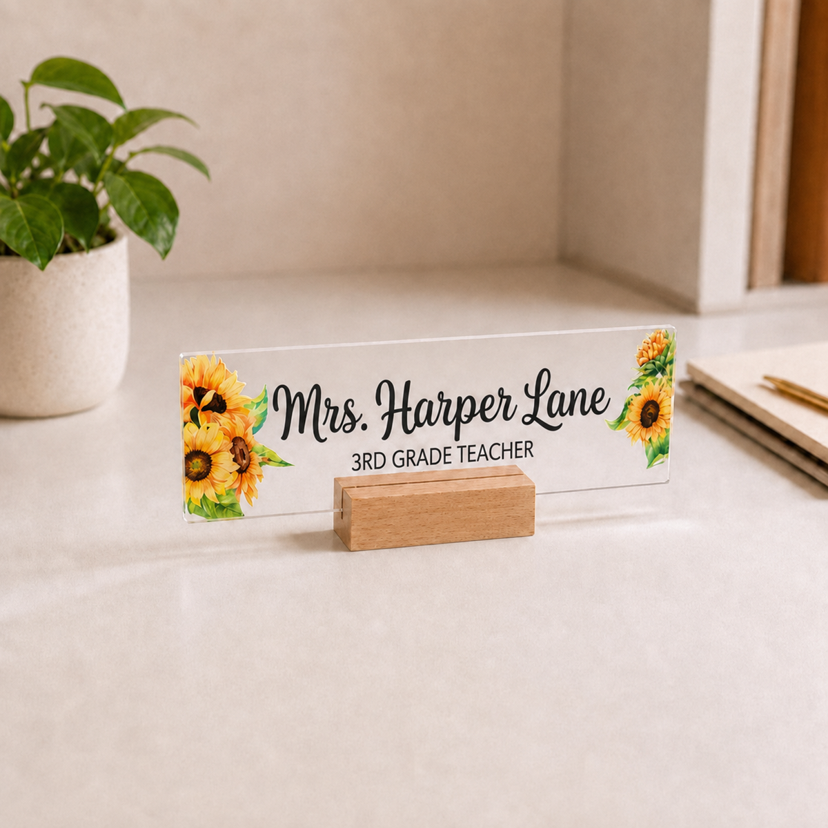 Personalized acrylic teacher nameplate with sunflowers on a small wooden base.
