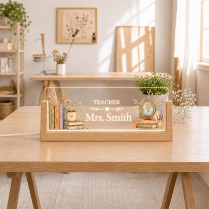 Personalized Teacher LED acrylic desk nameplate with books and globe framing a centered name.