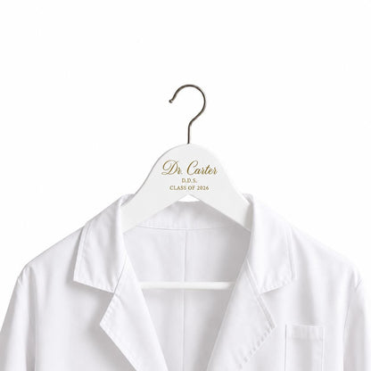 White personalized dentist hanger holding a white coat