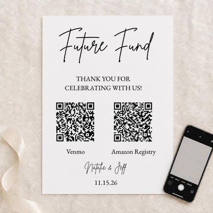 Overhead view of the wedding Future Fund sign with two realistic QR code examples and a phone nearby