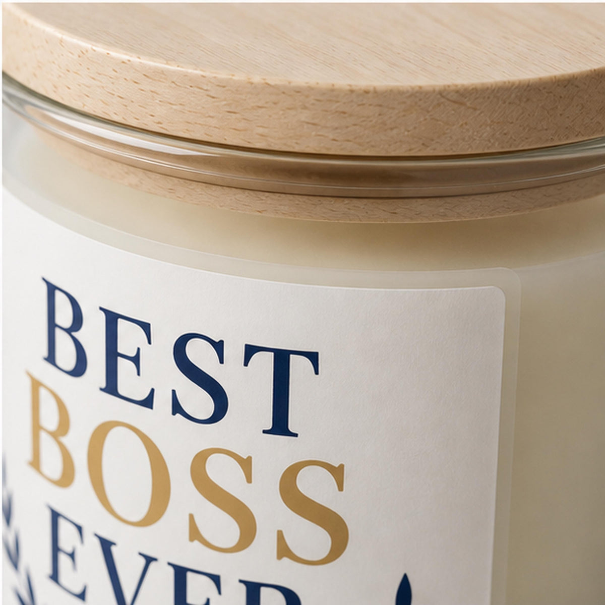 Close detail of a white candle label applied to clear glass