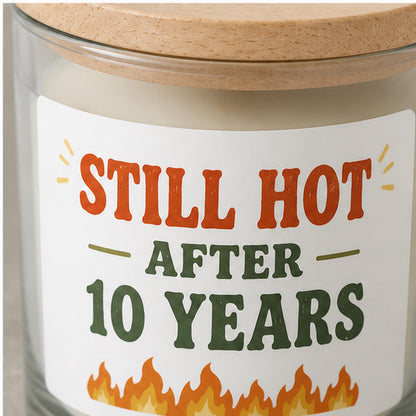 Close detail of an anniversary label applied to clear candle glass