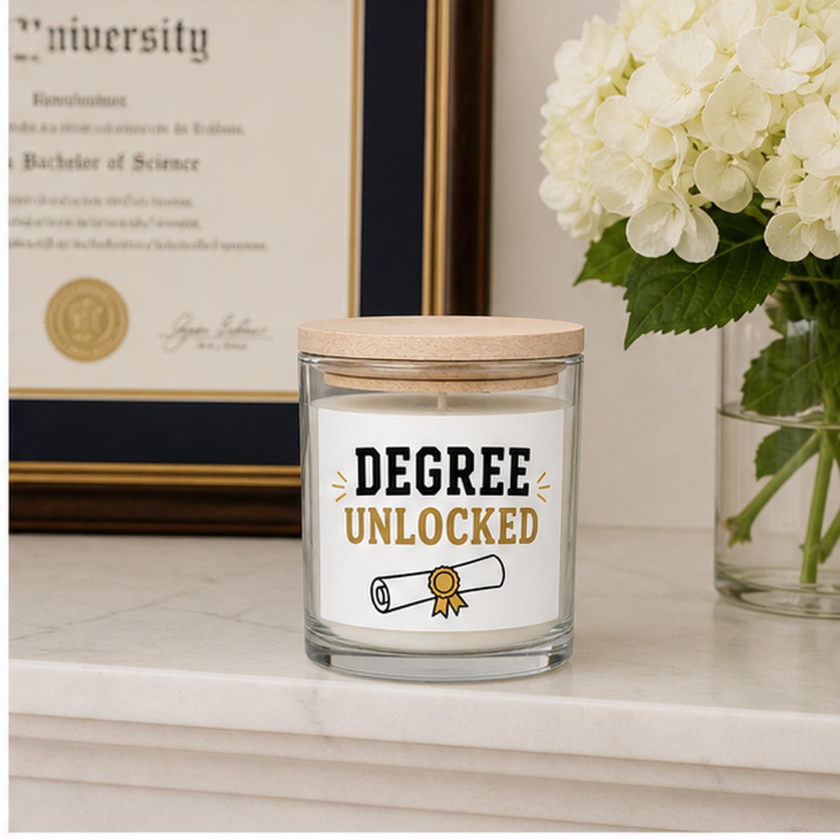 Graduation candle staged beside a framed diploma