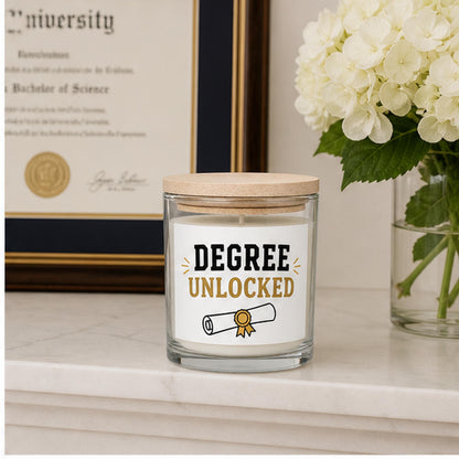 Graduation candle staged beside a framed diploma