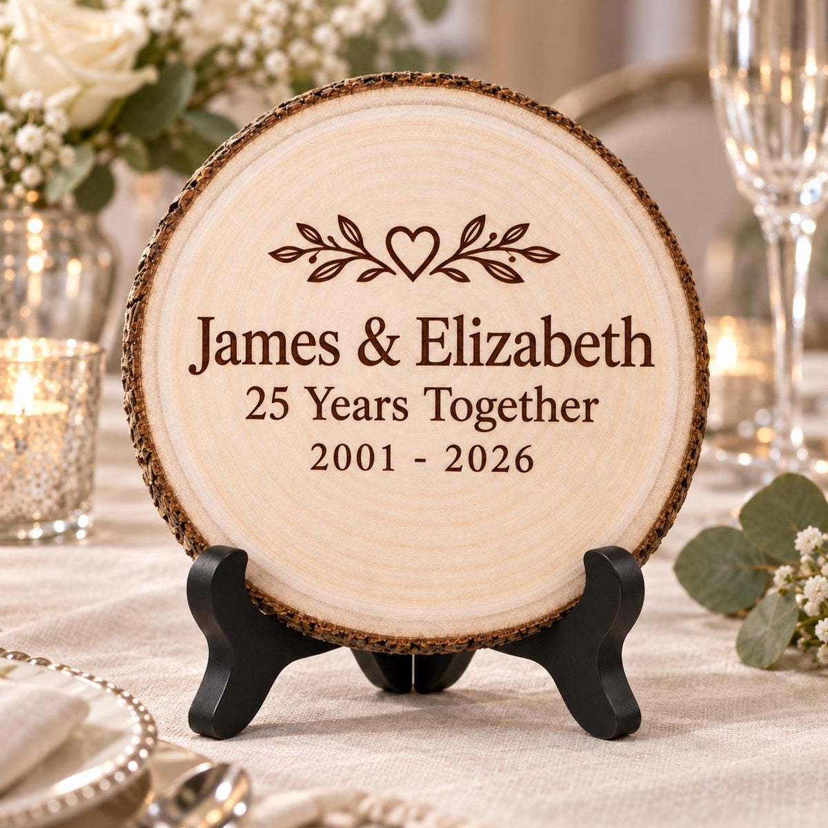 Anniversary Wood Slice displayed on the optional black wooden stand in a matching setting. Approved thumbnail September 25, 2026.