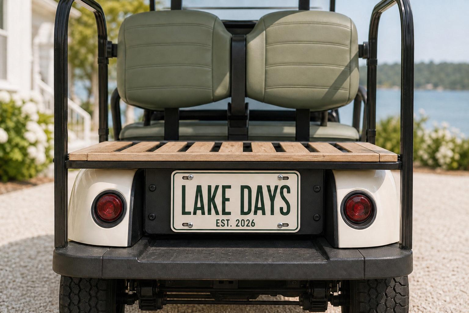 Personalized license plate mounted on a golf cart beside a lake