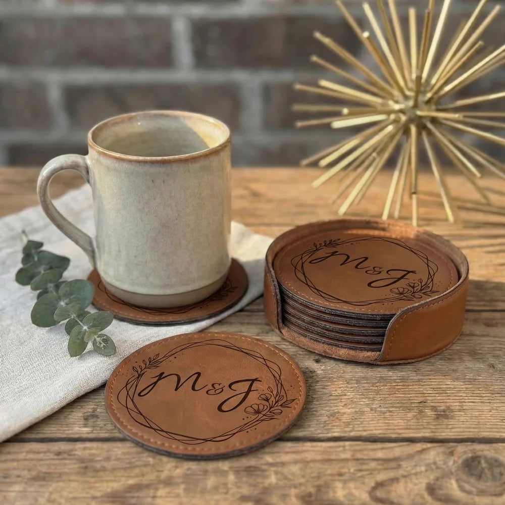 Personalized round leather coasters arranged beside a ceramic cup