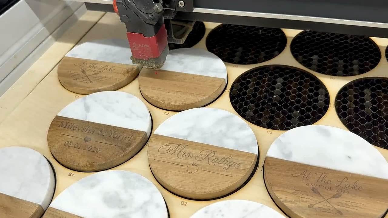 Personalized coasters being engraved in the My Maravia workshop