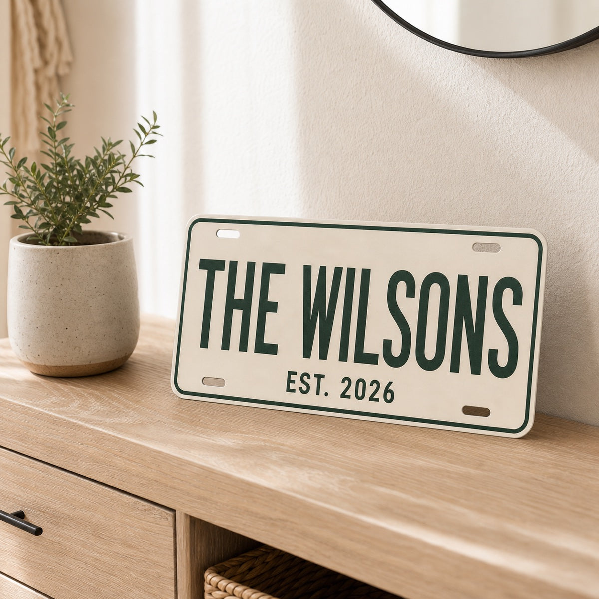 Personalized cream license plate displayed on a warm oak console