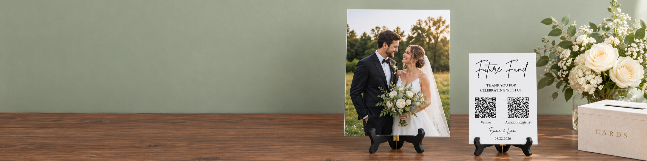 Wedding photo acrylic sign and personalized Future Fund sign on black stands on a walnut gift table against a sage wall