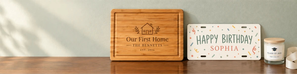 Personalized housewarming cutting board, birthday license plate and graduation candle on a warm wood table